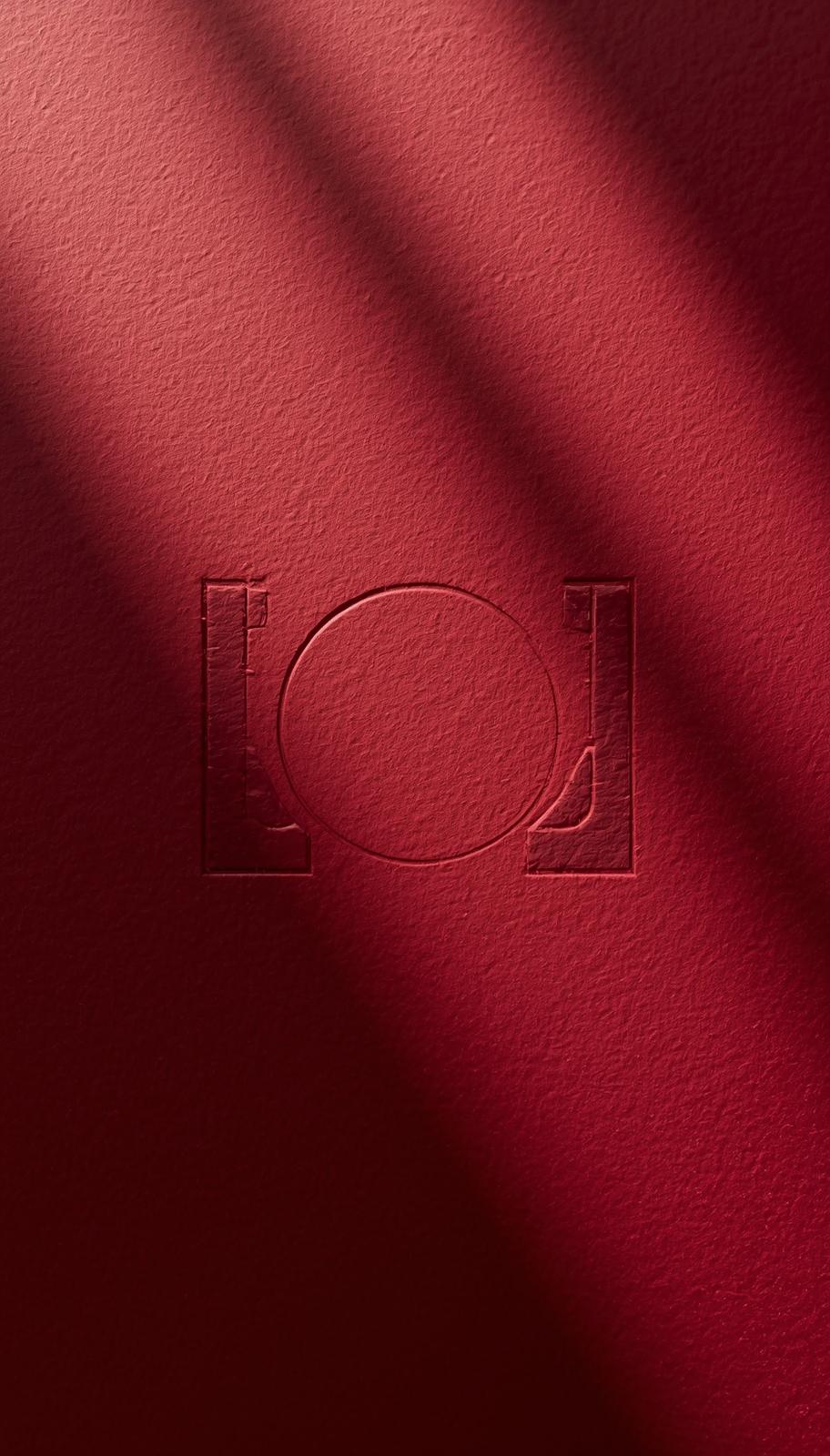 Embossed Portal logo on red textured surface